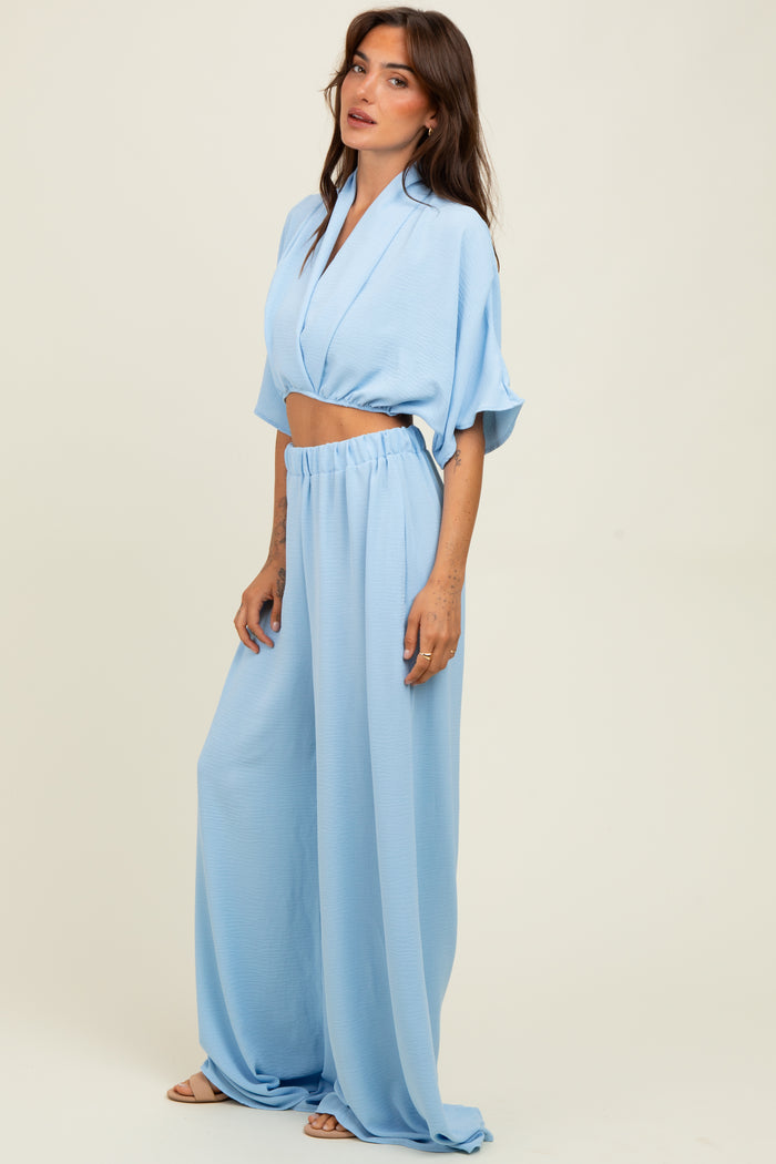 woman wearing a light blue cropped blouse and matching wide-leg pants in a relaxed fit