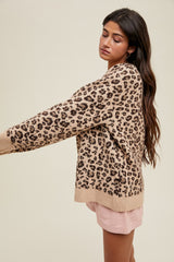woman wearing a beige leopard print oversized sweater with long sleeves and relaxed fit