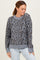 woman wearing a gray leopard print sweater with a relaxed fit and ribbed cuffs and hem