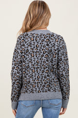 woman wearing a gray leopard print maternity sweater with a relaxed fit and back view