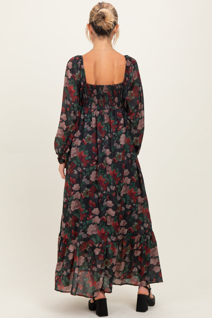woman wearing a floral long sleeve maternity maxi dress with a square back and ruffle hemline