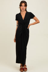 woman wearing a black short sleeve maxi dress with a twisted front detail