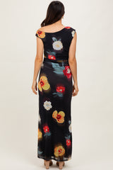 woman wearing a black floral maxi dress with a scoop back and colorful flower prints