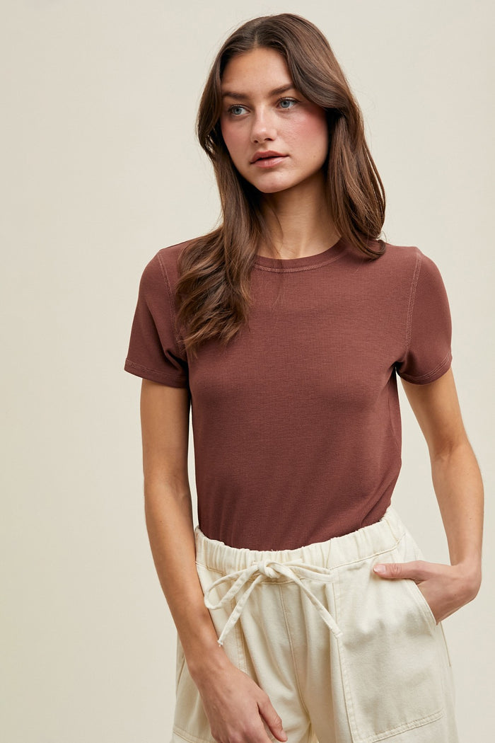 woman wearing a brown short sleeve tee paired with cream-colored drawstring pants