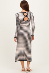 woman wearing a striped long sleeve midi dress with a unique back cutout detail