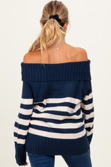 woman wearing a navy and white striped off-the-shoulder maternity sweater from the back with long sleeves