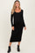 woman wearing a black long sleeve maternity dress with a scoop neckline and baby bump visible