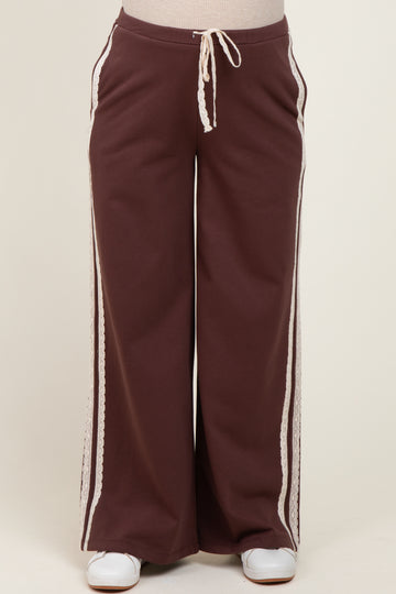 maternity wear in dark brown wide-leg pants with lace detailing and an elastic drawstring waistband