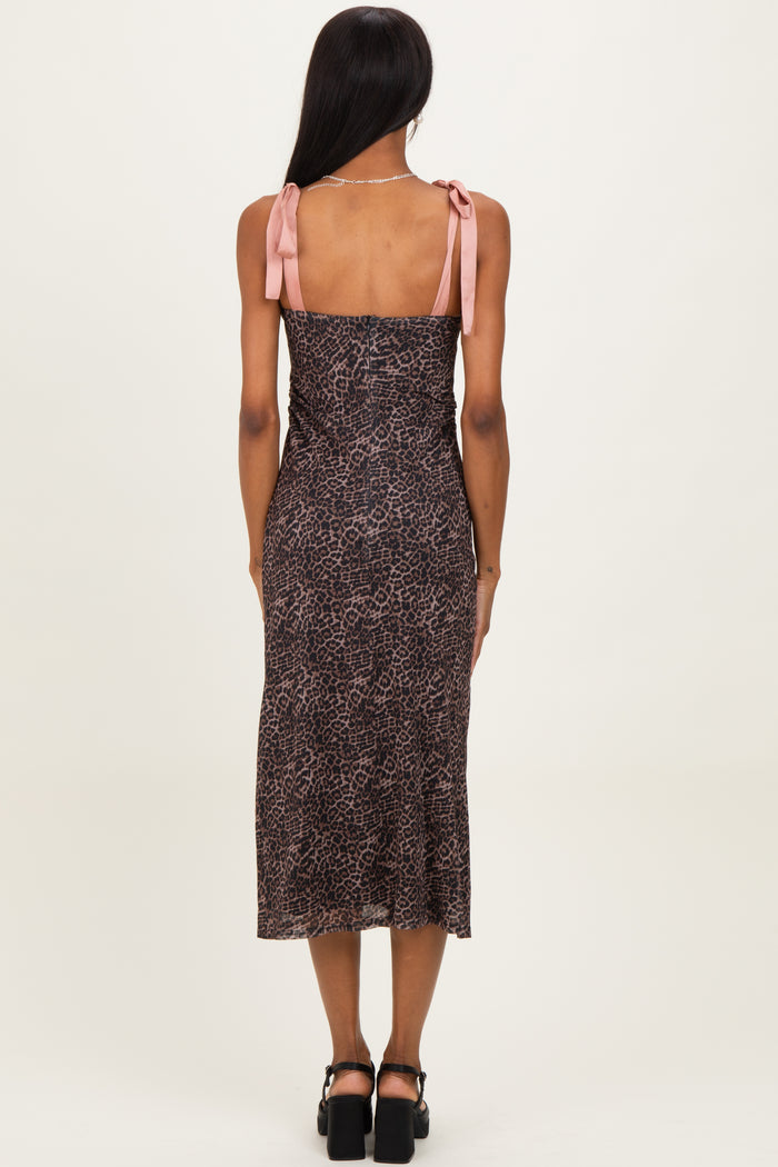woman wearing a brown leopard print midi dress with pink tie straps, shown from the back