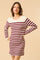 woman wearing a striped maroon and cream sweater dress with button details on shoulders