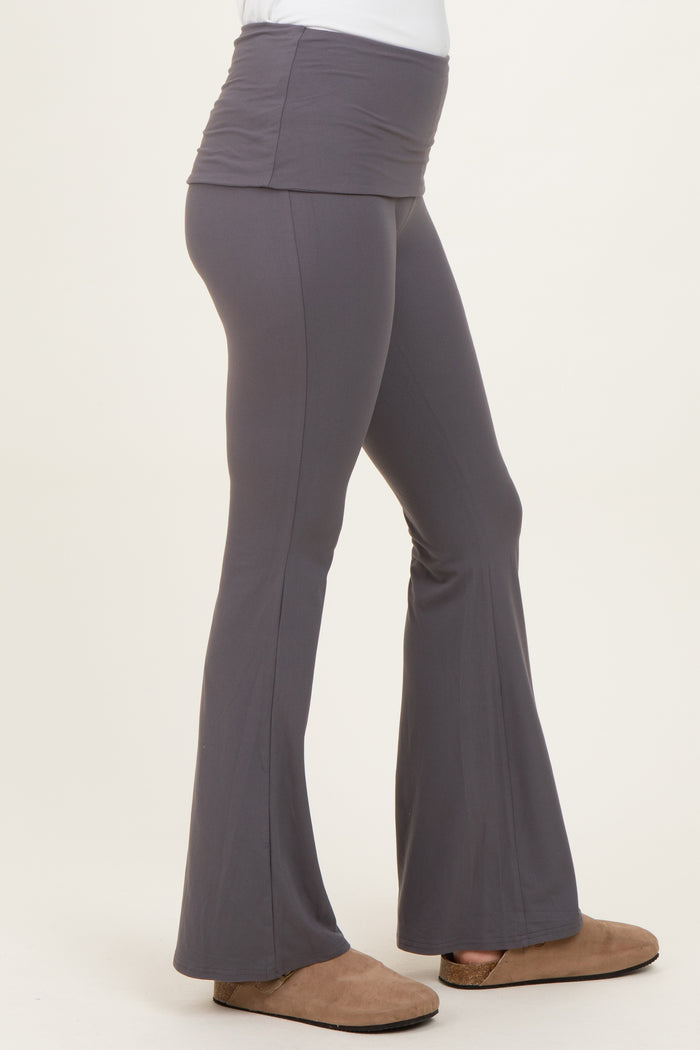 woman wearing gray maternity flared leggings with a wide waistband and side view of a baby bump