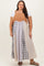 woman wearing a plus size color block maxi dress with a tan corduroy top and plaid skirt, paired with brown sandals