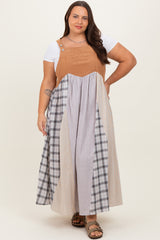 woman wearing a plus size color-blocked maxi dress with a brown top and plaid skirt sections