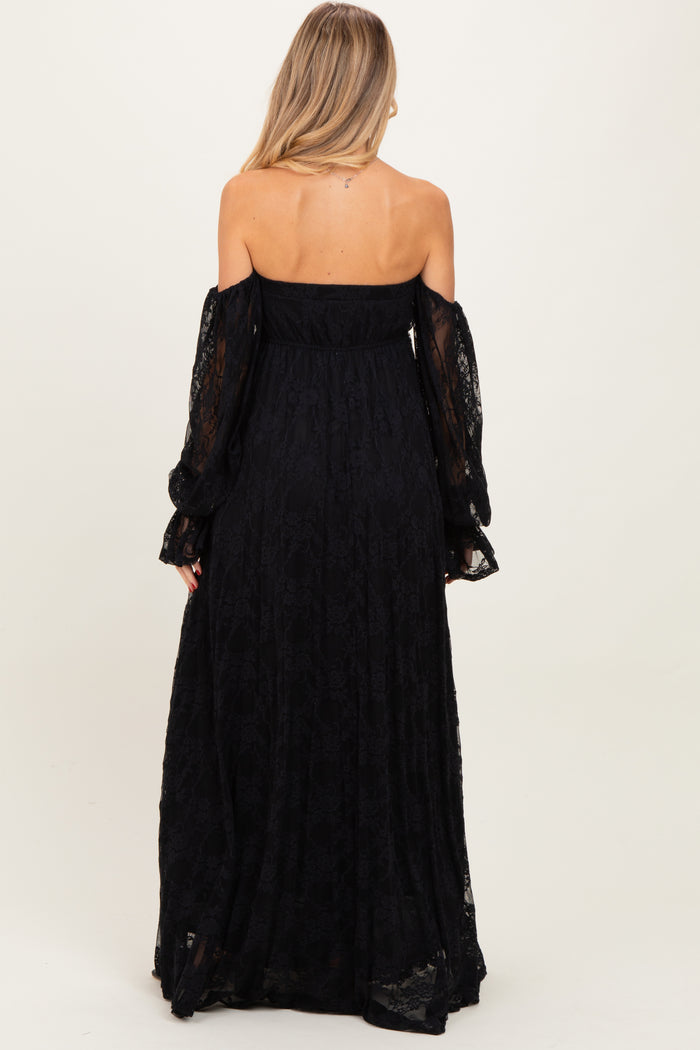 woman wearing a black off-the-shoulder lace maternity dress with long sleeves, showing a flowing silhouette from the back