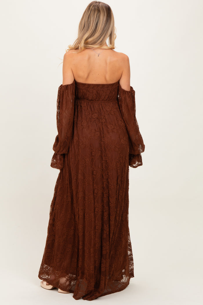 woman wearing a brown off-the-shoulder maternity lace maxi dress with long sleeves and a flowing silhouette