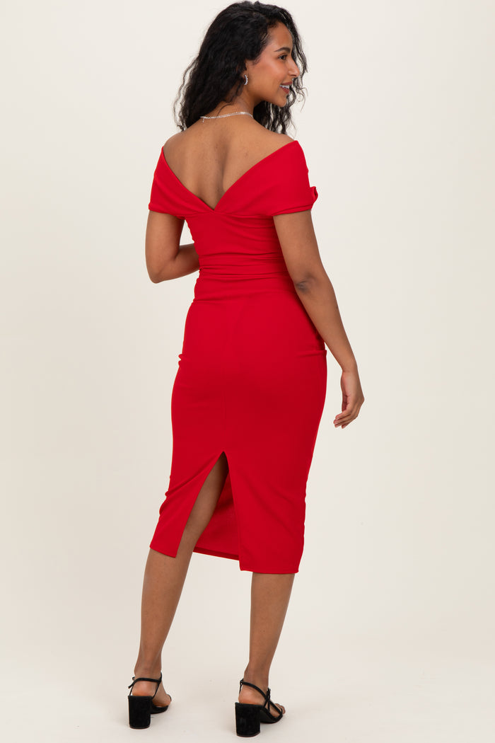 woman wearing a red off-shoulder midi maternity dress with a back slit, showing her baby bump
