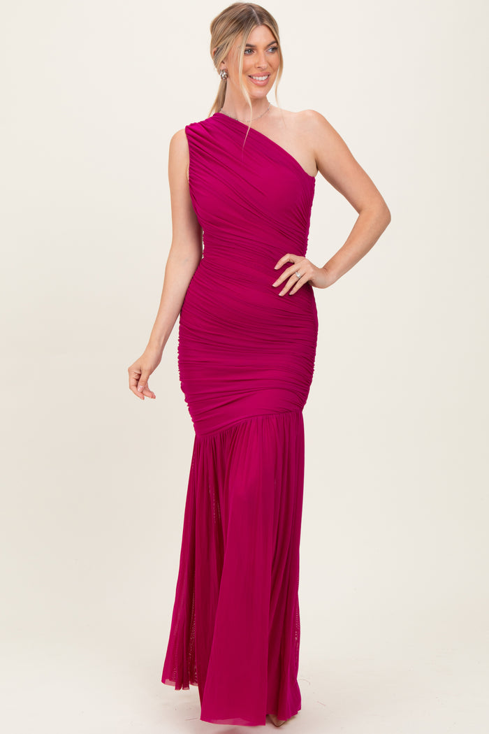 woman wearing a fuchsia one-shoulder ruched evening gown with a mermaid silhouette