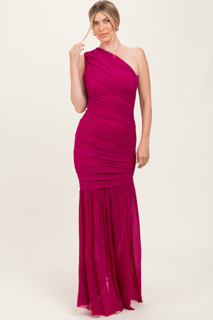 woman wearing a hot pink one-shoulder evening gown with ruched detailing and a mermaid hemline