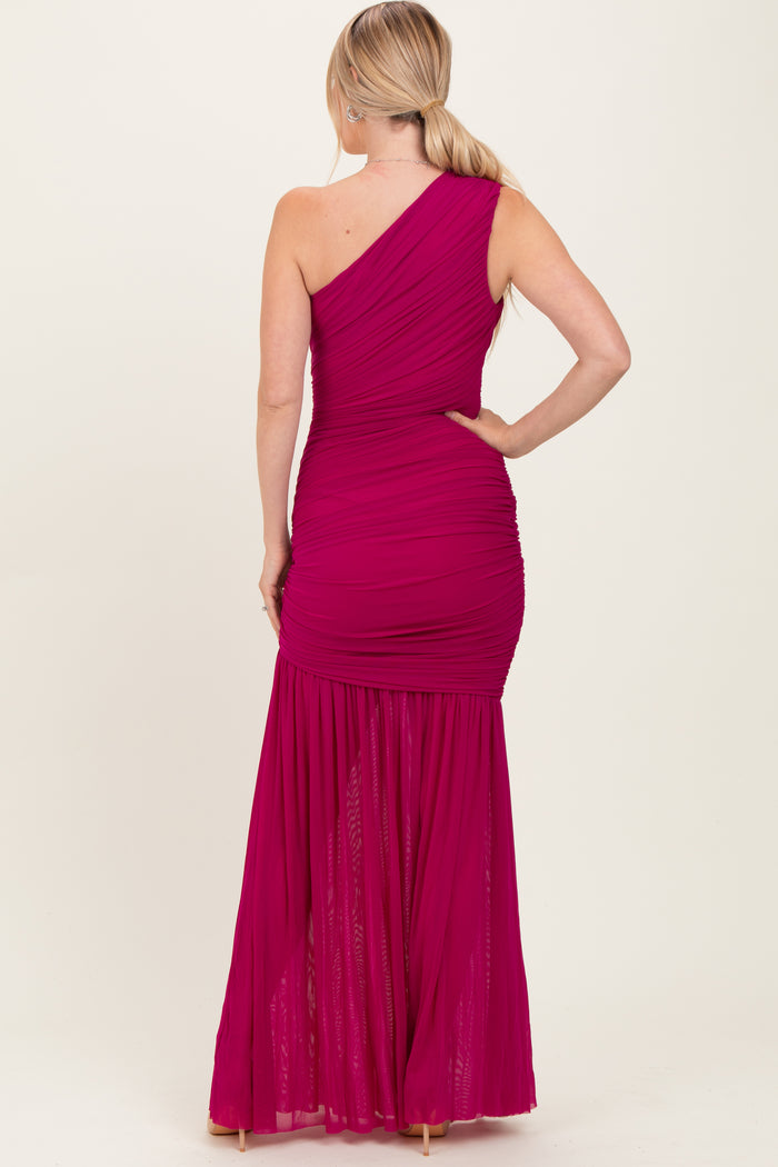 woman wearing a magenta one-shoulder ruched maxi dress with a flowy skirt