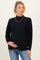 woman wearing a black maternity sweater with a relaxed fit and holding her baby bump