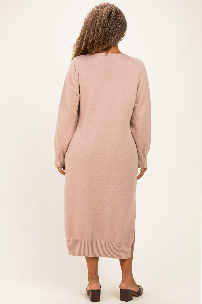 woman wearing a light pink long sleeve sweater dress with a slit at the hem and back detailing