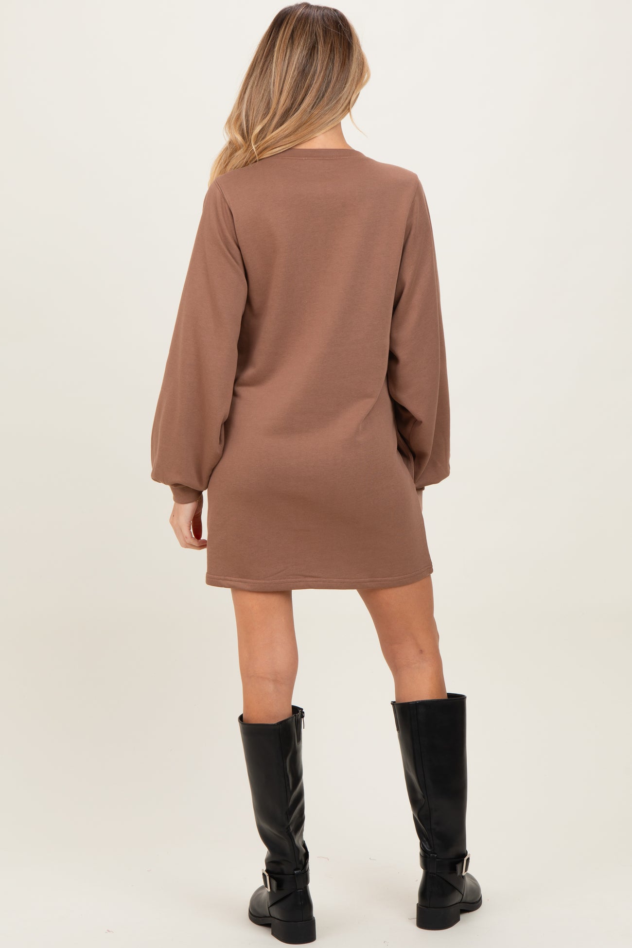 woman wearing a brown long sleeve maternity dress with a relaxed fit and balloon sleeves, viewed from the back