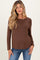woman wearing a brown long sleeve maternity top with a relaxed fit and a visible baby bump