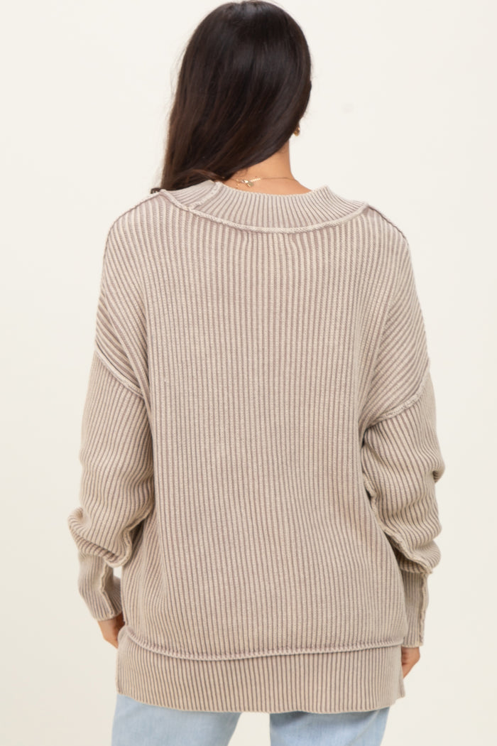 woman wearing a beige ribbed oversized sweater with a relaxed fit