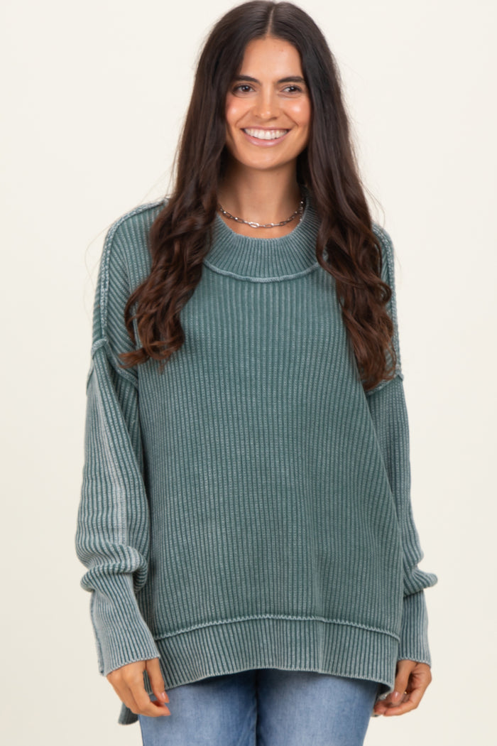woman wearing a soft green oversized ribbed sweater with a round neckline and long sleeves
