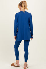 woman wearing a royal blue maternity top and matching leggings, showing a relaxed fit from the back