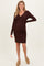 woman wearing a brown ribbed maternity dress with a tie detail and a visible baby bump