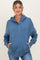 woman wearing a blue maternity hoodie with button details and front pockets, styled casually with light jeans