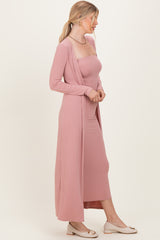 woman wearing a dusty pink ribbed maxi dress with a matching cardigan and beige flats