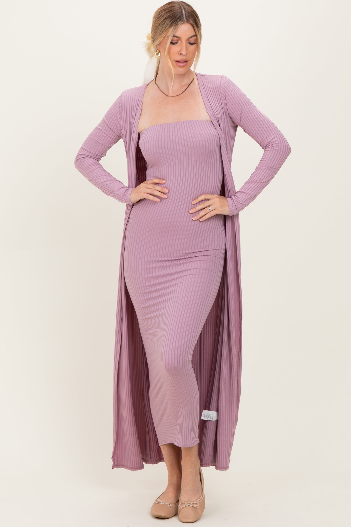 woman wearing a light mauve ribbed maxi dress with a long matching cardigan