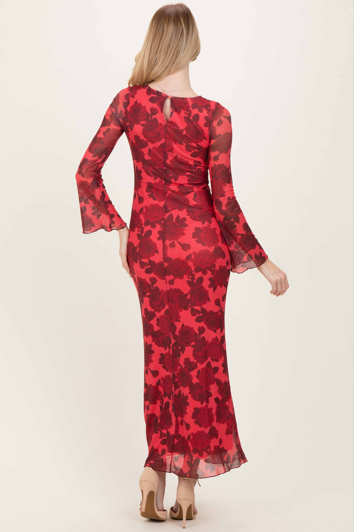woman wearing a long red floral print dress with bell sleeves and a keyhole back detail