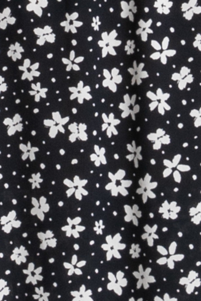 black floral print fabric with white flowers on a dark background