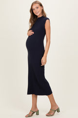 woman wearing a navy ribbed maternity dress and holding her baby bump