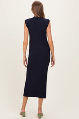 woman wearing a navy blue ribbed sleeveless maternity dress, showing the back view