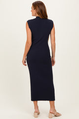 woman wearing a navy ribbed sleeveless midi dress with a fitted silhouette and scalloped neckline