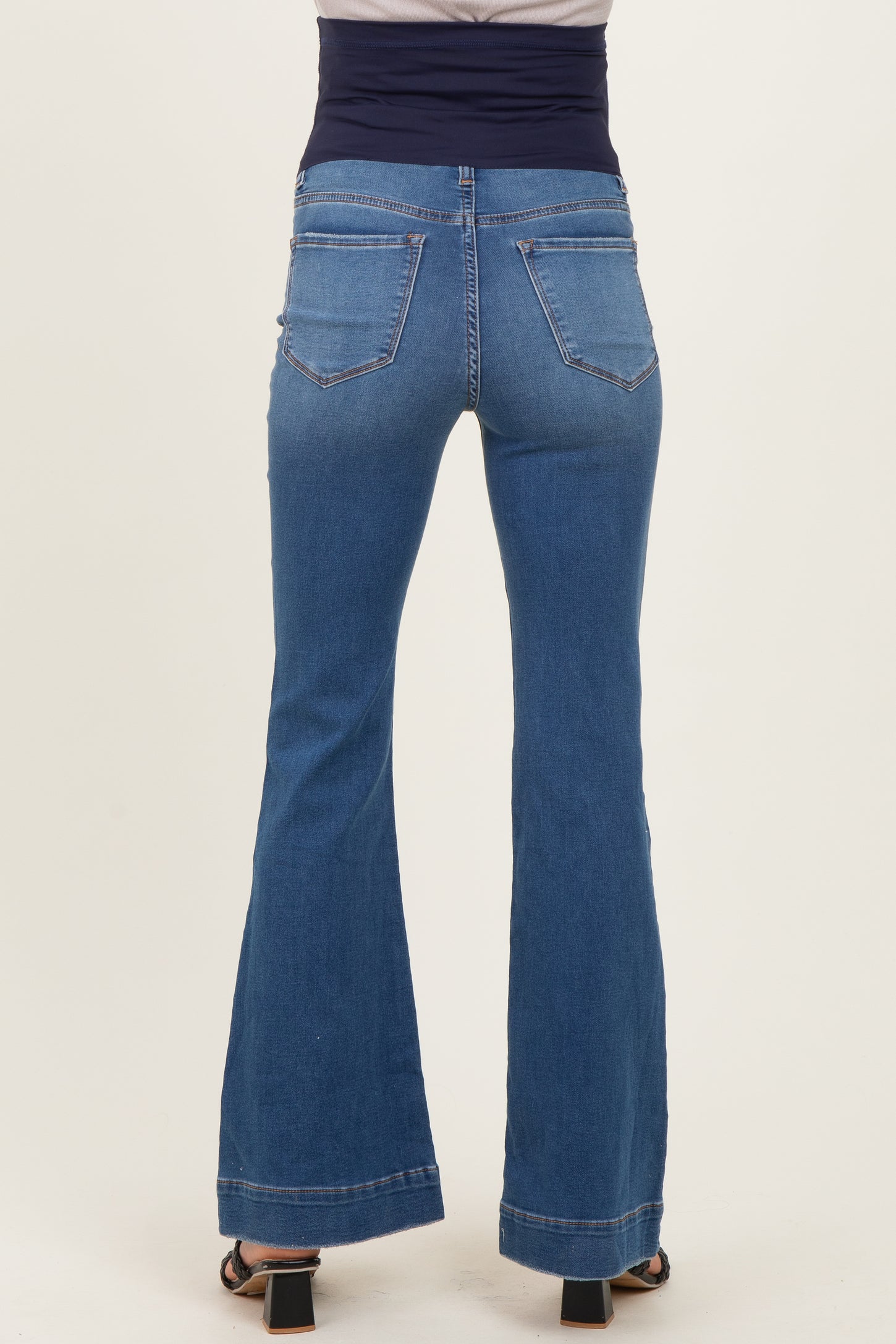 maternity wear blue flared jeans shown from the back with a comfortable waistband
