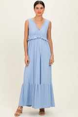 woman wearing a light blue sleeveless maxi dress with a ruffled bodice and tiered bottom