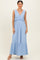 woman wearing a light blue sleeveless maxi dress with a ruffled bodice and tiered bottom