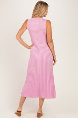 woman wearing a pink ribbed knit maxi dress with a sleeveless design and a fitted silhouette