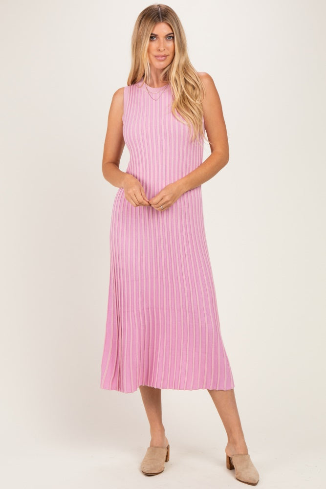 woman wearing a sleeveless pink ribbed midi dress with a flared hem and a relaxed fit