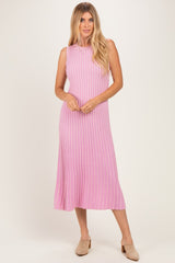 woman wearing a sleeveless pink ribbed midi dress with a flared hem and a relaxed fit