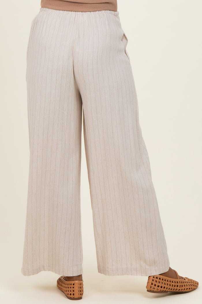 woman wearing light beige striped maternity wide-leg pants with a relaxed fit