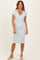 woman wearing a light blue and white striped midi dress with short sleeves and a V-neckline