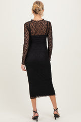 woman wearing a black lace long sleeve maternity dress with a fitted silhouette and mid-length hemline
