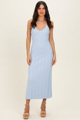 woman wearing a light blue ribbed knit maxi dress with a deep v-neck and spaghetti straps