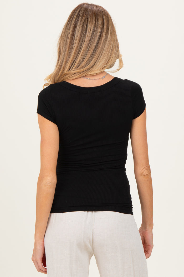 woman wearing a black short sleeve fitted maternity top with ruching at the back